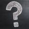 A question mark drawn on a chalkboard.